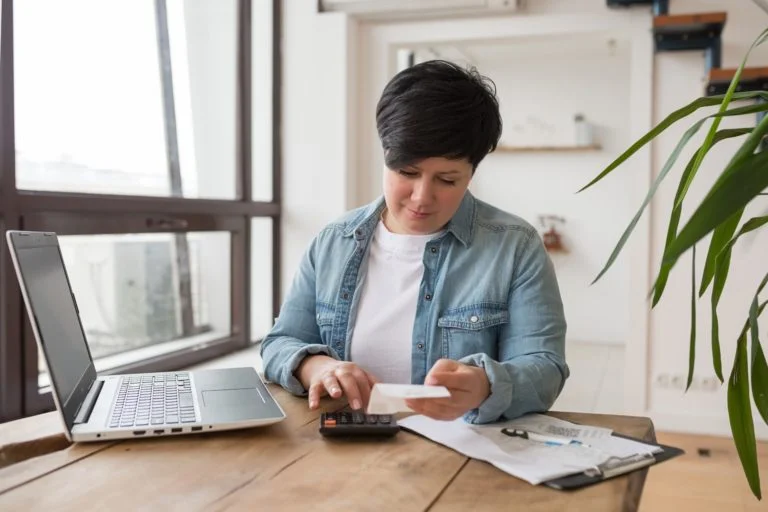 a person sitting at a desk using a laptop